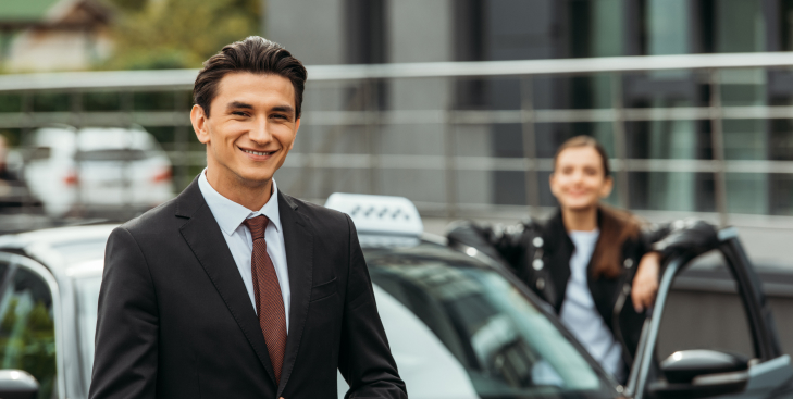 selective-focus-of-smiling-businessman-and-taxi-dr-2023-11-27-05-13-01-utc-1.jpg